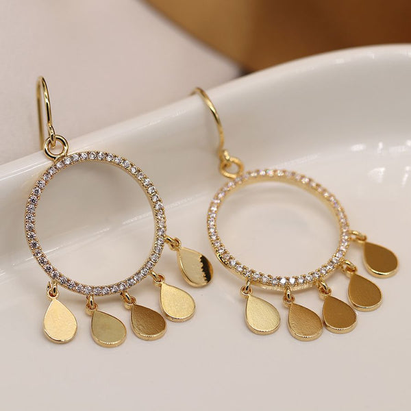Gold plated crystal inset circle drop earrings with multiple golden teardrop charms.