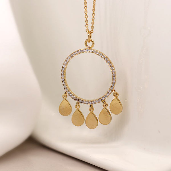 Gold plated crystal inset circle drop pendant with multiple golden teardrop charms on a fine golden chain  Matching earrings available