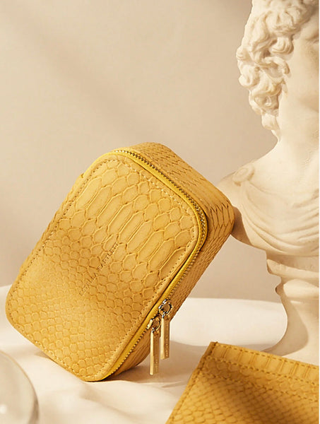 The Estella Bartlett Mini Jewellery Box in Mustard Yellow is the perfect solution for organizing your collection. With compartments for rings, earrings, necklaces, bangles, and watches, this timeless and vibrant Mustard snake print box is a must-have for any fashionista. Use it as a bedside box or take it with you on your travels for impeccable outfit coordination.