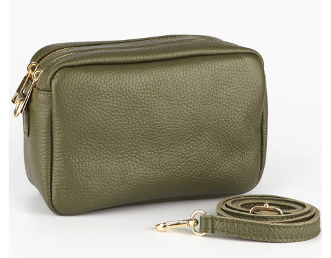 Elevate your style with the Ana Double Section Leather Cross body Bag in khaki green. Crafted from luxurious Italian leather, this camera style bag features two compartments and a zipped inner pocket for your essentials. The removable leather strap allows for versatile wear. Gold hardware and a secure zip closure complete the sophisticated look.    Removable and Adjustable Strap Double Compartment Inner Pocket with Zip Closure Zip Closure 20cm x 14cm x 8cm 100% Leather Wipe Clean