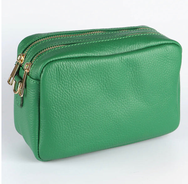 Elevate your style with the Ana Double Section Leather Cross body Bag in vibrant green. Crafted from luxurious Italian leather, this camera style bag features two compartments and a zipped inner pocket for your essentials. The removable leather strap allows for versatile wear. Gold hardware and a secure zip closure complete the sophisticated look.    Removable and Adjustable Strap Double Compartment Inner Pocket with Zip Closure Zip Closure 20cm x 14cm x 8cm 100% Leather Wipe Clean  