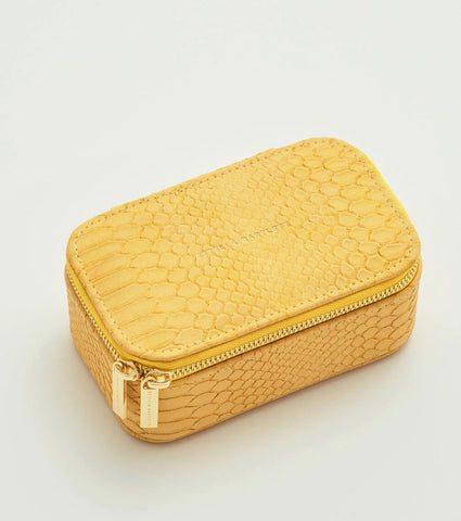 The Estella Bartlett Mini Jewellery Box in Mustard Yellow is the perfect solution for organizing your collection. With compartments for rings, earrings, necklaces, bangles, and watches, this timeless and vibrant Mustard snake print box is a must-have for any fashionista. Use it as a bedside box or take it with you on your travels for impeccable outfit coordination.