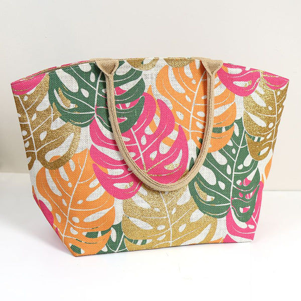 Elevate your style with our Leaf Jute Bag in Pink. Made from durable jute and adorned with a playful pink, green, and gold monstera leaf print, this bag is both stylish and environmentally friendly. The cotton handles add comfort while carrying your essentials. Make a statement with this vibrant bag!