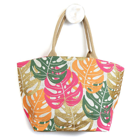 Elevate your style with our Leaf Jute Bag in Pink. Made from durable jute and adorned with a playful pink, green, and gold monstera leaf print, this bag is both stylish and environmentally friendly. The cotton handles add comfort while carrying your essentials. Make a statement with this vibrant bag!