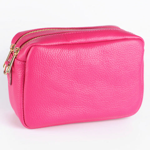 Elevate your style with the Ana Double Section Leather Cross body Bag in fuchsia pink. Crafted from luxurious Italian leather, this camera style bag features two compartments and a zipped inner pocket for your essentials. The removable leather strap allows for versatile wear. Gold hardware and a secure zip closure complete the sophisticated look.    Removable and Adjustable Strap Double Compartment Inner Pocket with Zip Closure Zip Closure 20cm x 14cm x 8cm 100% Leather Wipe Clean
