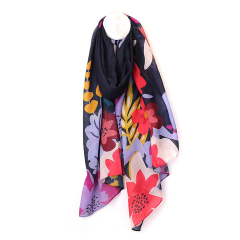 Crafted from Repreve, a sustainable yarn made from recycled plastic bottles, this navy blue scarf showcases a lively tropical print. Stylish and eco-friendly, it's the perfect accessory for adding a touch of paradise to any outfit.  Approximate size 90cm x 180cm 48% Repreve 52% Polyester