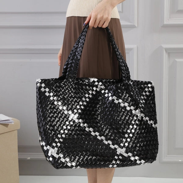 Stylish and functional, our PU leather Large Woven / Weave Tote  is the perfect accessory for the fashion-forward individual. The distinctive wide weave pattern with a silver stripe adds a touch of sophistication to any outfit, making it the ideal choice for your Summer holidays. Stay effortlessly stylish and organized with this must-have tote. Also included is a pouch to keep your valuables safe.  Approx - 45cm (Bottom) 54cm (Top) x 29cm x 19cm