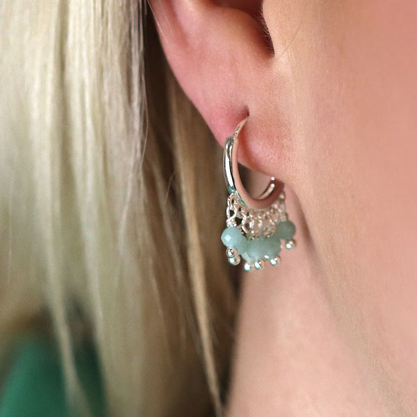 Silver plated hoop earrings with a row of dainty amazonite beads along the bottom edge