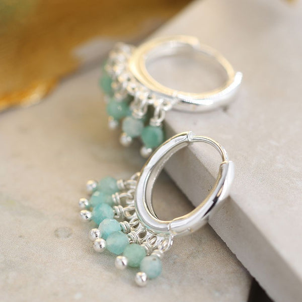 Silver plated hoop earrings with a row of dainty amazonite beads along the bottom edge