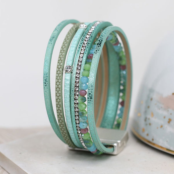 Aqua leather multistrand bracelet with crystals, mixed textures and blue/green mix crystal beads. Fastened with a magnetic clasp.