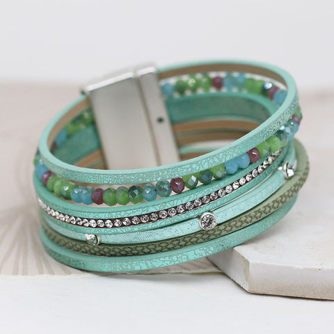 Aqua leather multistrand bracelet with crystals, mixed textures and blue/green mix crystal beads. Fastened with a magnetic clasp.