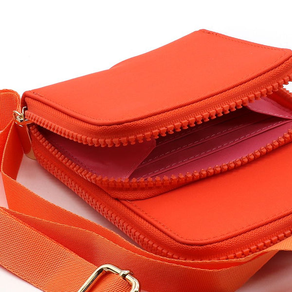 Bright orange phone bag made from recycled nylon with a double zipped pocket design, a vibrant contrasting pink lining and a removable strap. with gold hardware  Approximate size 18cm x 11cm