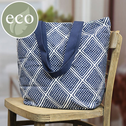 Navy blue and white geo diamond print tote bag with star print lining and navy blue handles.
