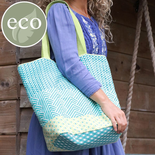 Aqua blue, lime green and white geometric multi print tote bag with star print lining and lime green handles.  Cotton