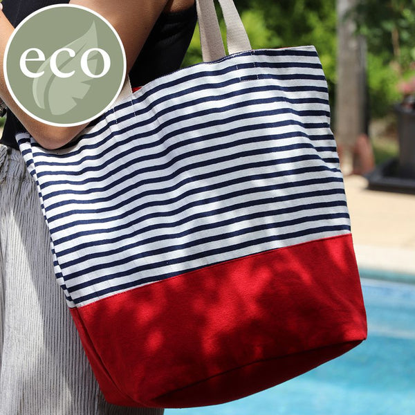Navy and white cotton stripe beach bag with deep red colour block base and webbing strap.