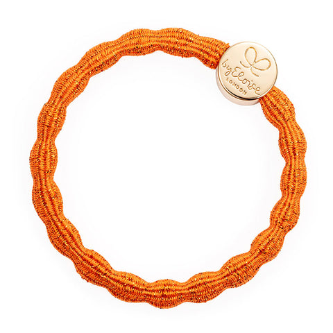 Gold Circle charm on a Metallic Orange elastic hair band.  Add some sparkle to your hair and wrist!